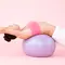 A photo of a woman on a yoga ball