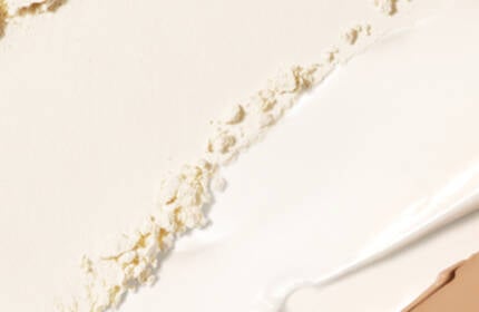 A close-up texture shot of crumbled cream-colored powder.