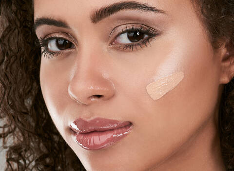 A photo of a woman with some makeup colors on face