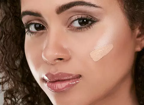 A photo of a woman with some makeup colors on face