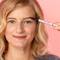 A person filling in their eyebrows with an eyebrow pencil