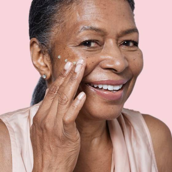 Woman applying face cream
