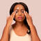 A person rubbing a cleaning balm into their face