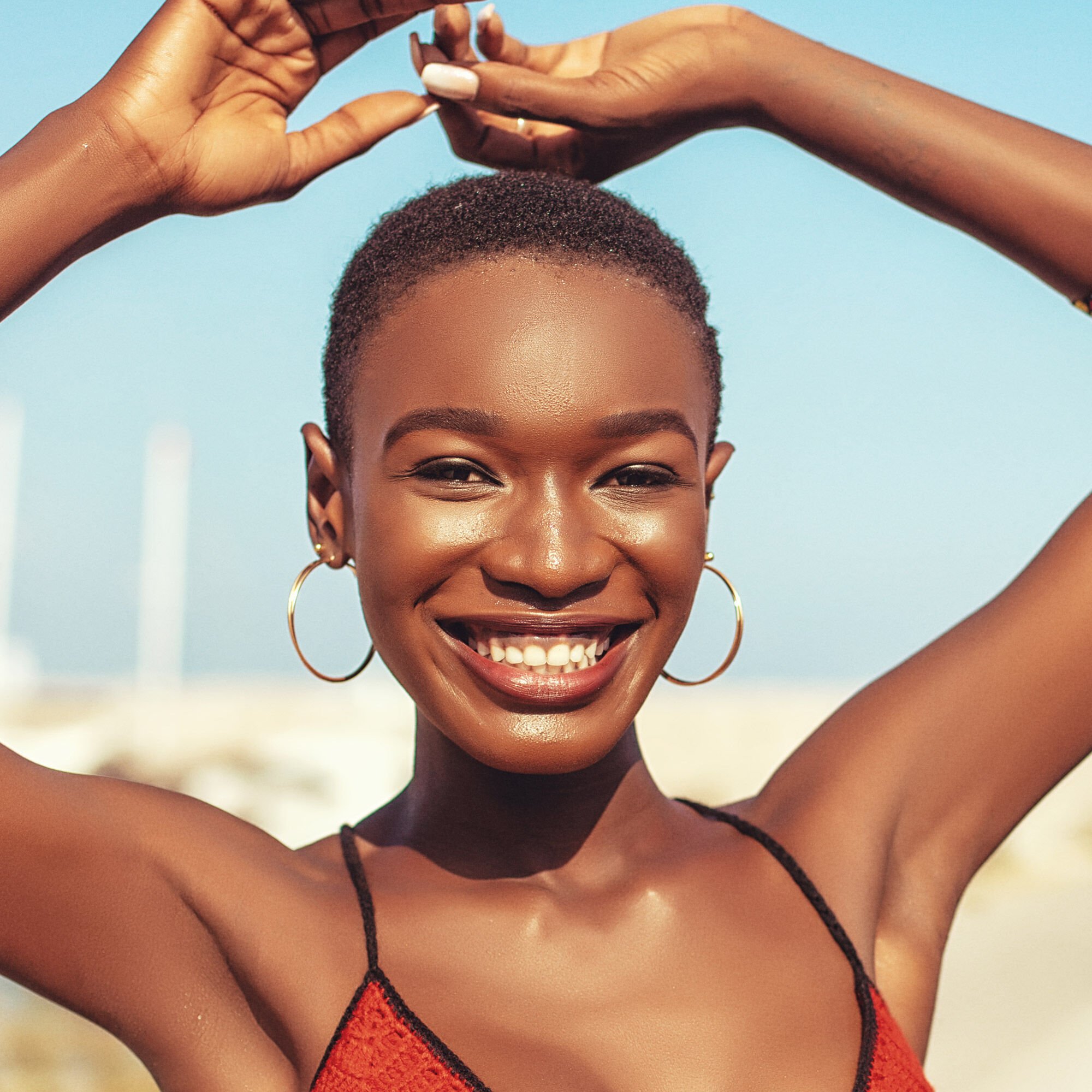A woman smiling with a summer glow