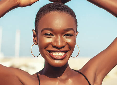 A woman smiling with a summer glow