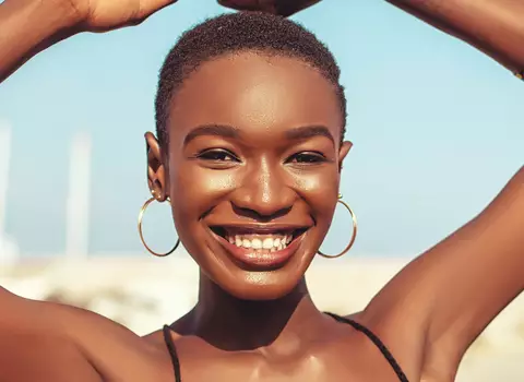 A woman smiling with a summer glow