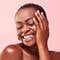 A photo of a brown skin woman smiling