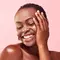 A photo of a brown skin woman smiling
