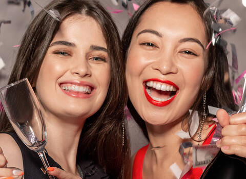 A photo of a women smiling at a party