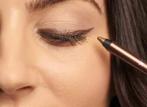 Woman Applying Bronze Eyeliner