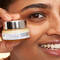 A photo of a woman holding Confidence in an Eye Cream 2% Super Peptide