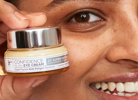A photo of a woman holding Confidence in an Eye Cream 2% Super Peptide