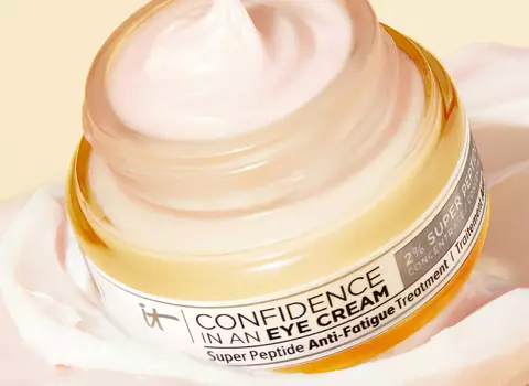 A photo of a woman holding Confidence in an Eye Cream 2% Super Peptide