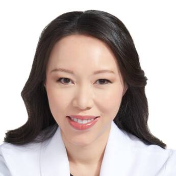 A closely cropped headshot of IT Cosmetics advisor Dr. Julia Tzu's face.