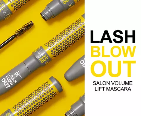 A photo of several tubes of IT Cosmetics Lash Blow Out mascara next to the text "Lash Blow Out. Salon volume lift mascara."