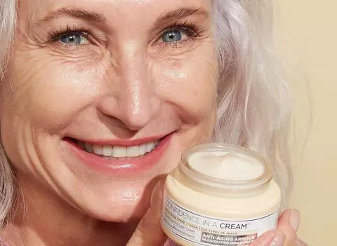 A photo of an older woman with anti-aging cream