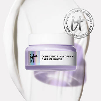 A photo of a jar of IT Cosmetics Confidence In A Cream Barrier Boost on a white background with a swipe of cream and an IT seal in the top right corner.
