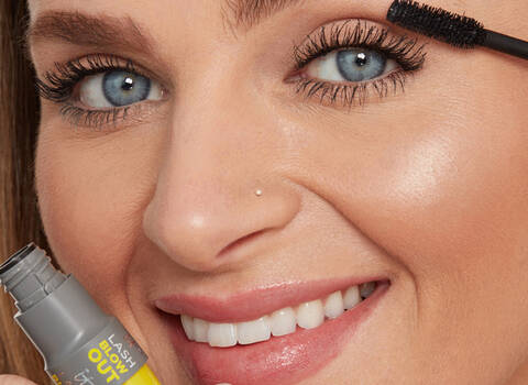 A photo of a woman using mascara