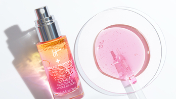 A product shot of Hello Results serum by IT cosmetics with a pink drop of serum on the side