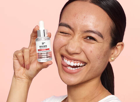 A person holding IT Cosmetics Bye Bye Breakout Salicylic Acid Treatment