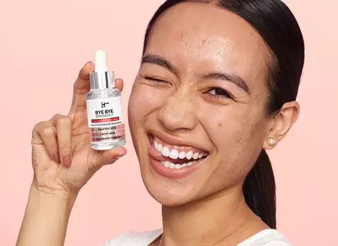 A person holding IT Cosmetics Bye Bye Breakout Salicylic Acid Treatment