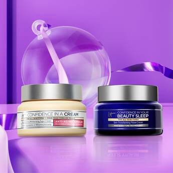 Two jars of IT Cosmetics Confidence In A Cream and Confidence In Your Beauty Sleep on a multicolored purple background.