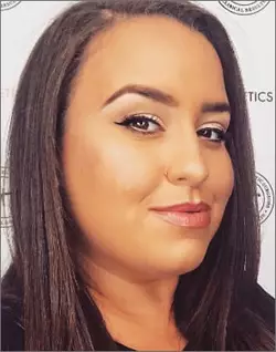A cropped photograph of a woman's smiling face