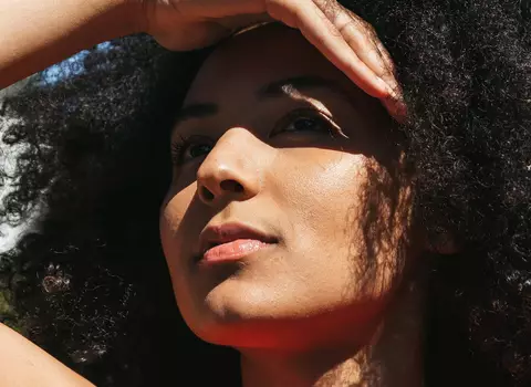 A model shielding her face from the sun