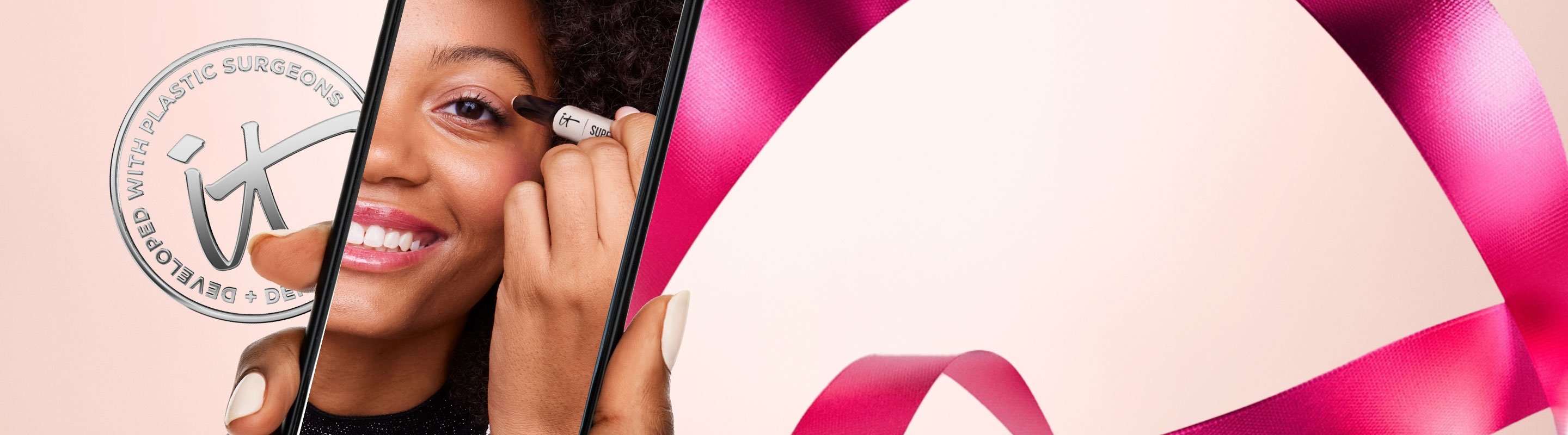 A banner featuring a silver IT Cosmetics seal with the words "Developed with plastic surgeons" next to a photo of someone holding a cell phone shows an image of a woman applying an eye shadow stick to her eyelids.